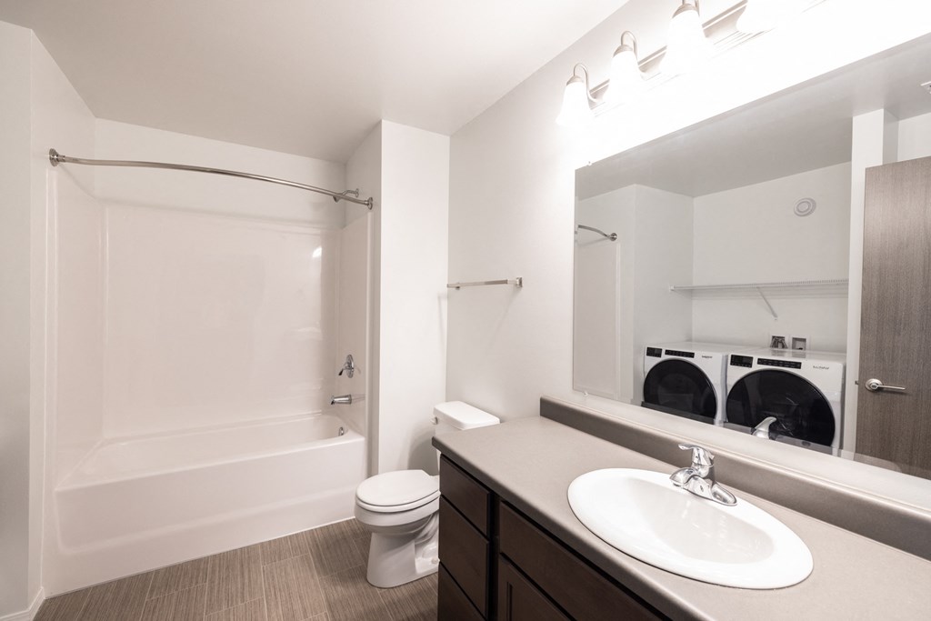 a bathroom with a sink toilet and shower and a mirror