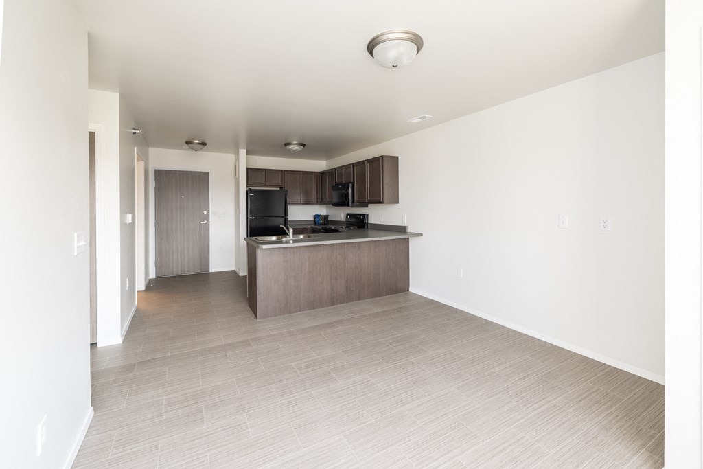 an empty living room and kitchen in an apartment
