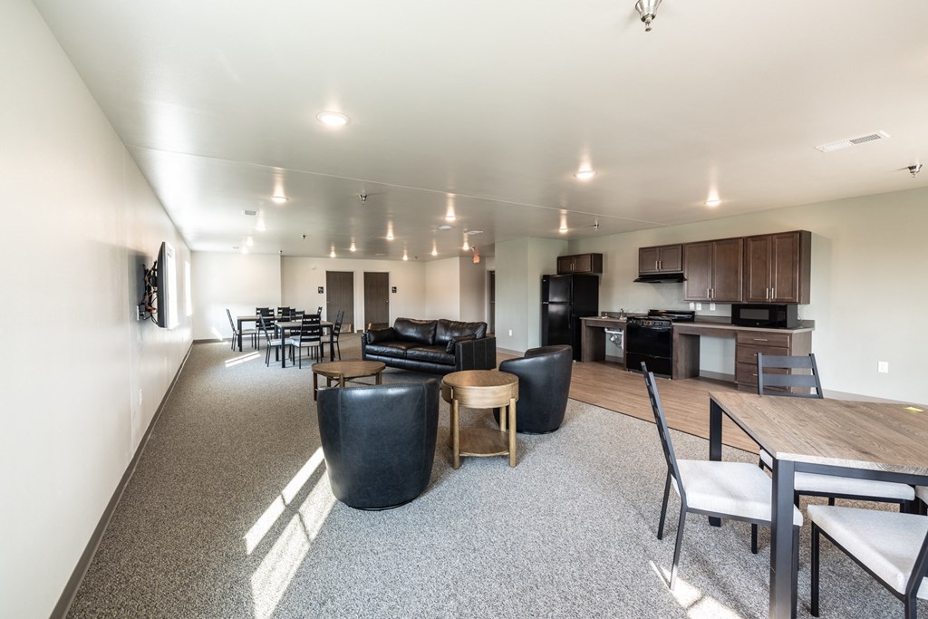 a large living room with furniture and a kitchen