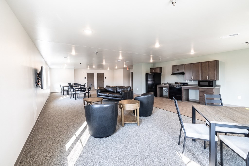 a large living room with furniture and a kitchen
