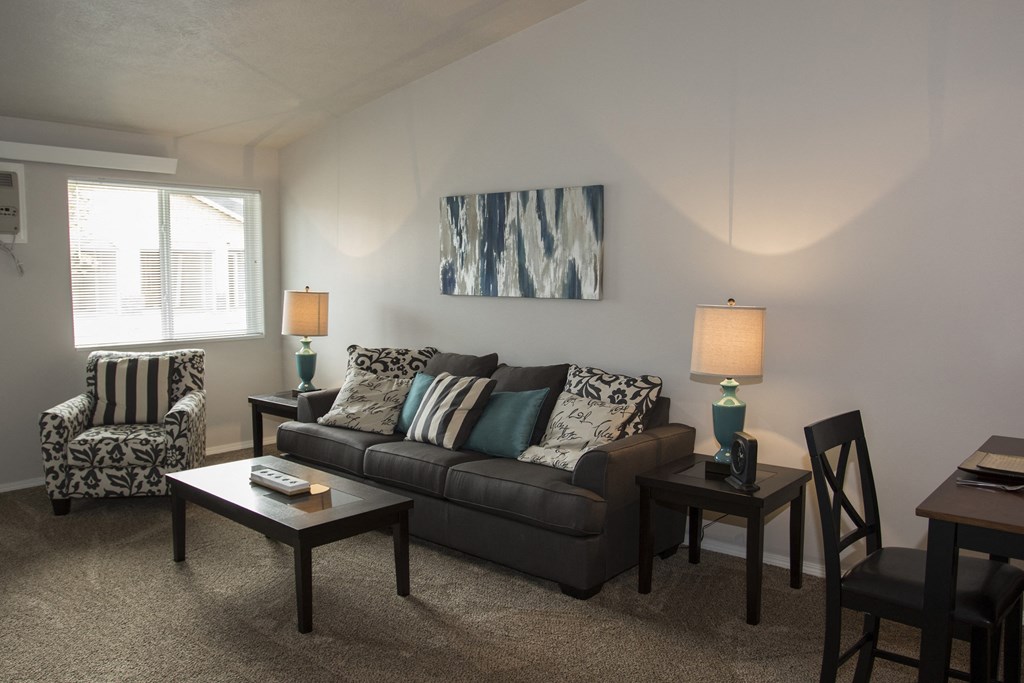 a living room with a couch and chairs and a table