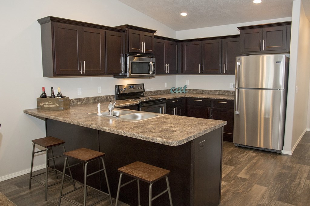 a kitchen with stainless steel appliances and granite counter tops