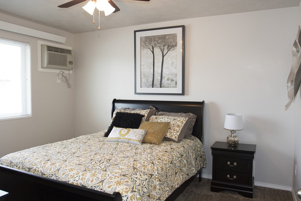 an overview of a bedroom with a bed and a air conditioner