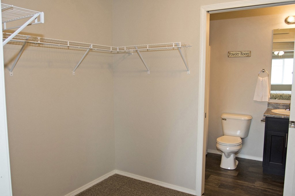 a bathroom with a toilet and a shower and a towel rack