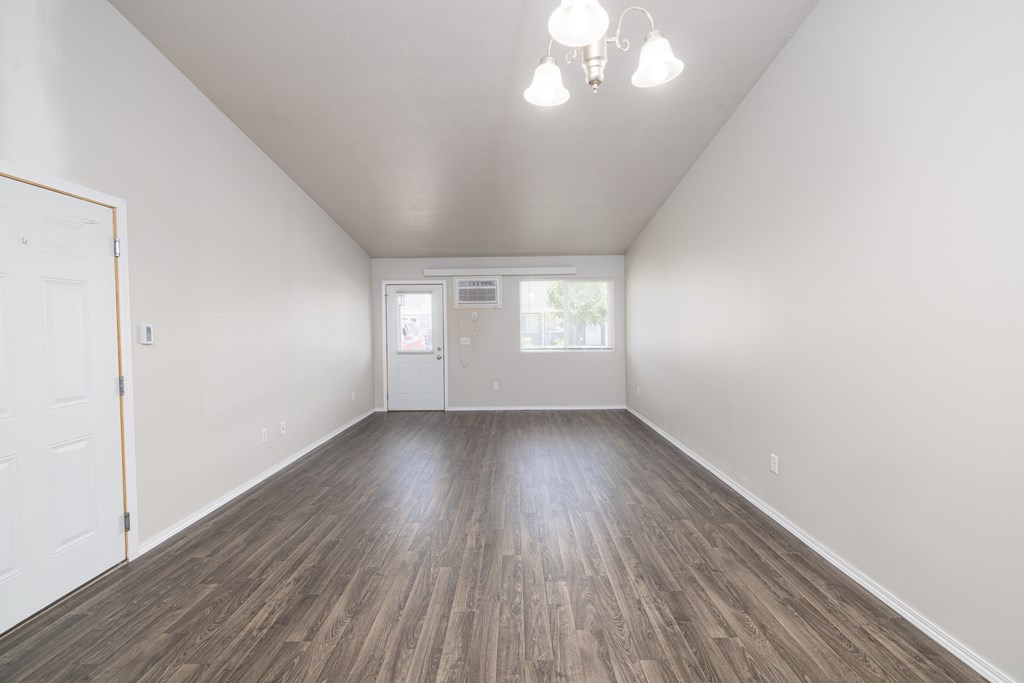 A room with wooden floors and white walls.