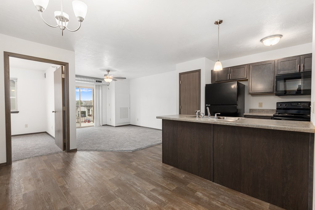 A kitchen area with a microwave, oven, and sink.
