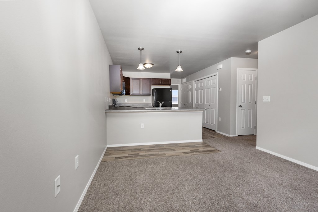 A spacious kitchen area with a countertop and cabinets.