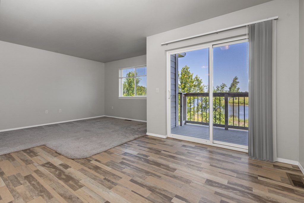 A room with a sliding glass door leading to a balcony.