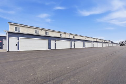 A long building with multiple garage doors.
