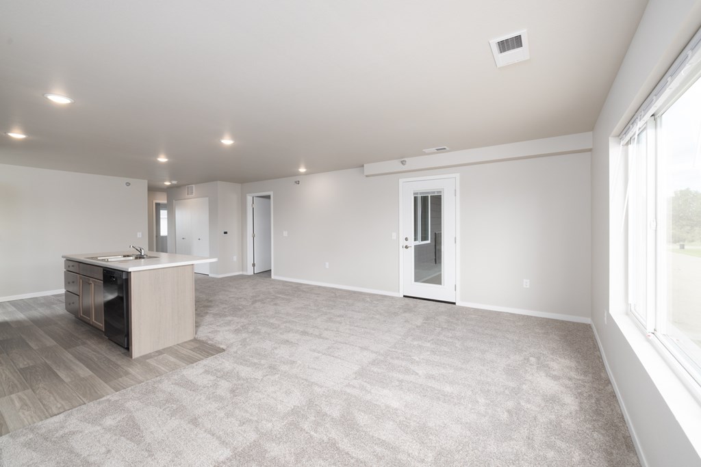 A spacious room with a desk and a window.