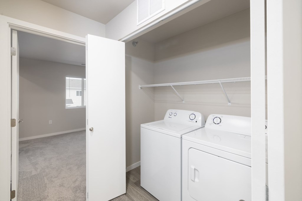 A white washer and dryer in a small laundry room.