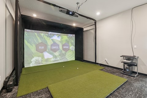 A projection screen in a room with a green carpet.