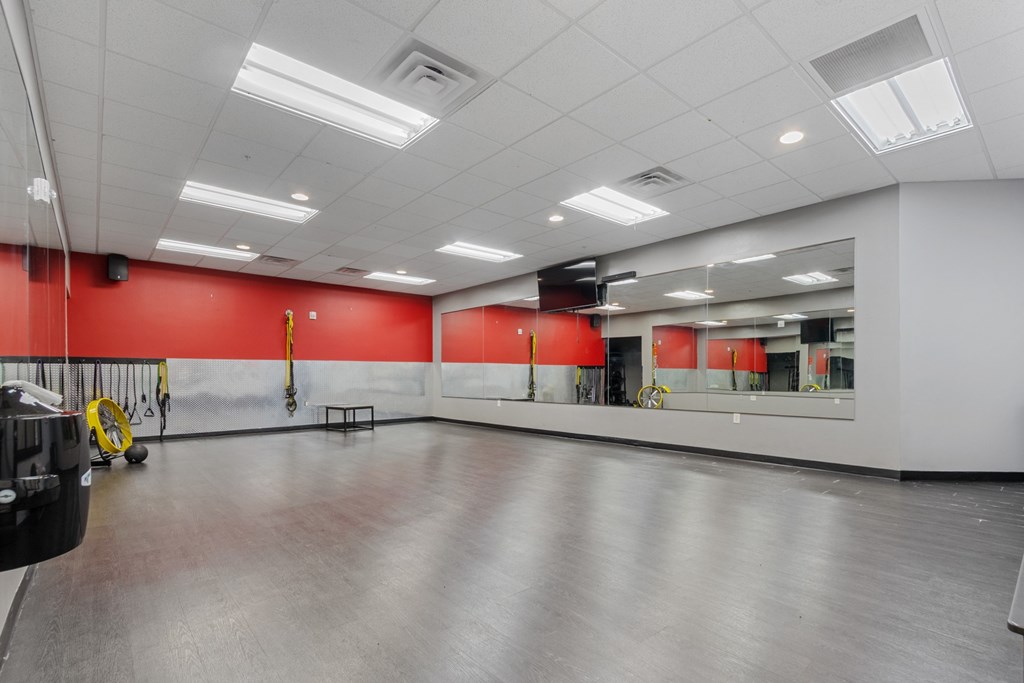 A large empty room with red walls and a grey floor.