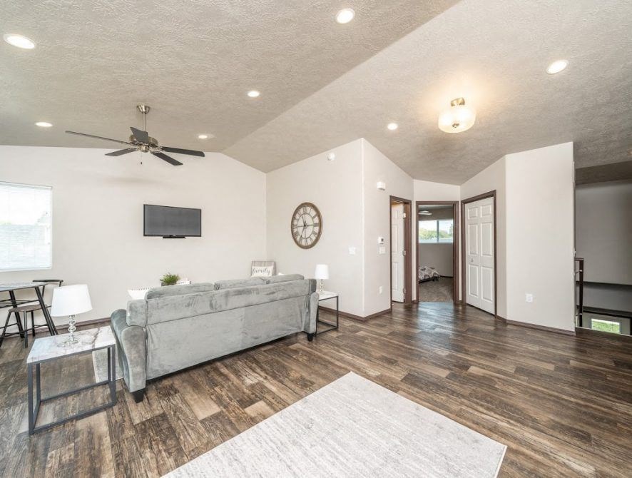 a living room with a couch and a ceiling fan