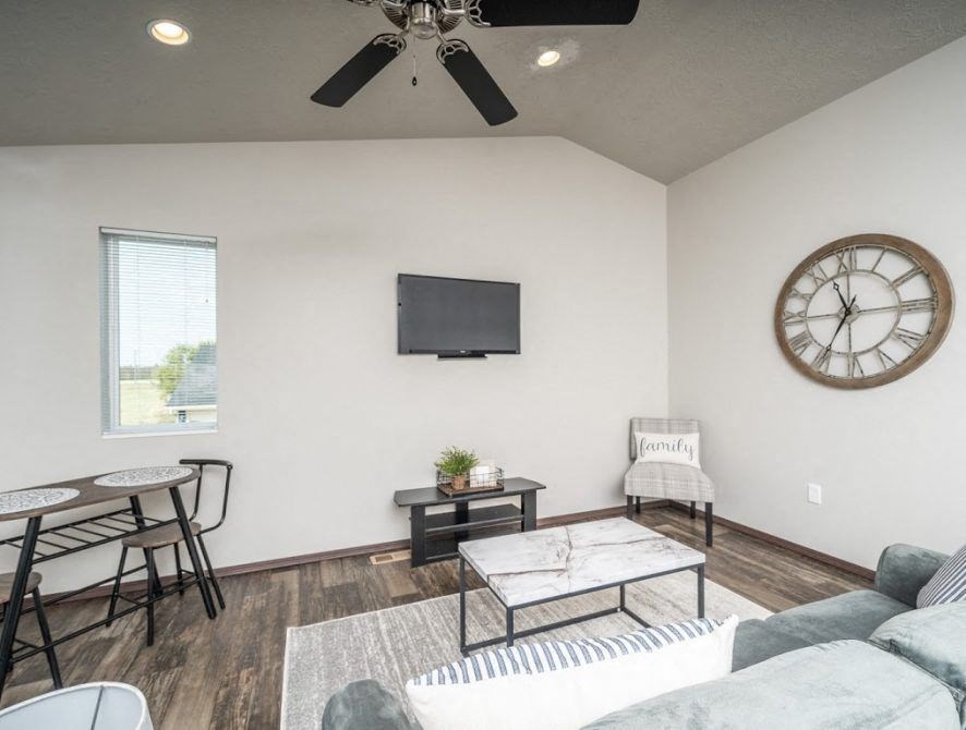 a living room with a large clock on the wall and a couch