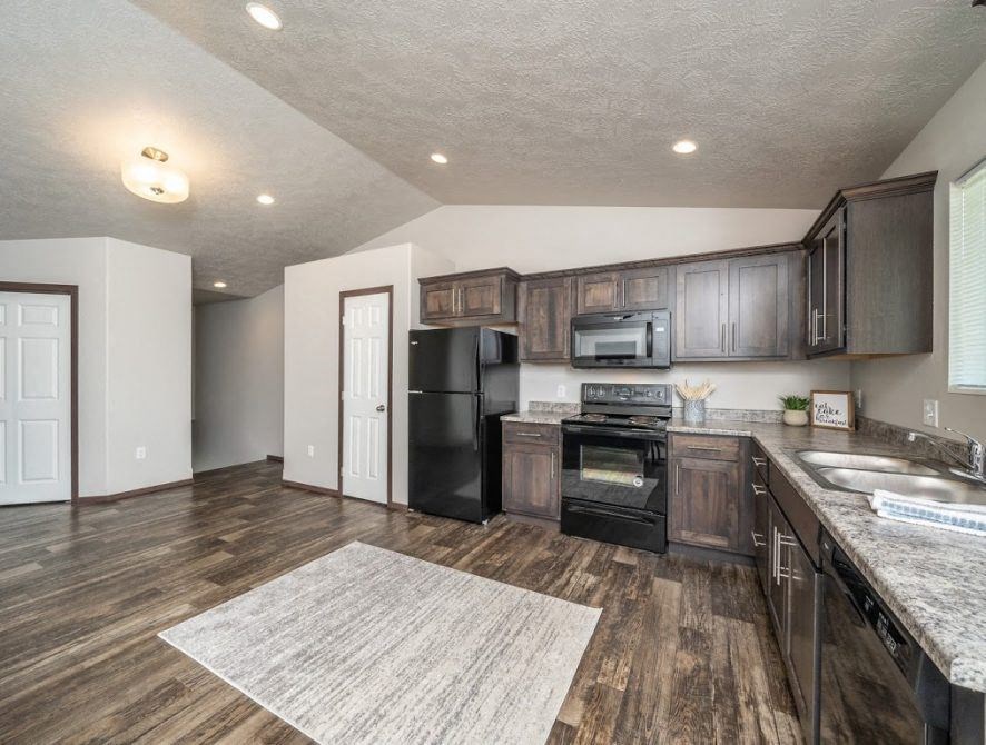 a kitchen with a stove refrigerator and a sink