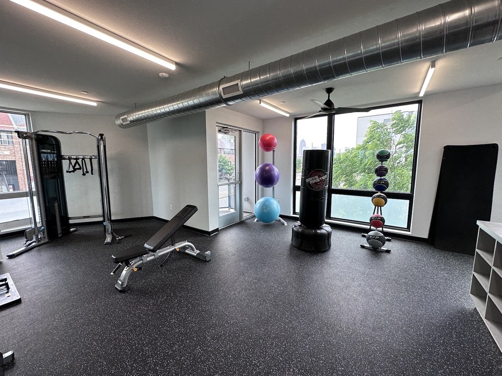 a workout room in a building with a large window