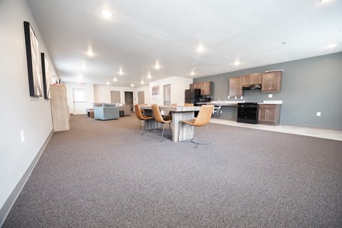 an open living room and kitchen with a table and chairs
