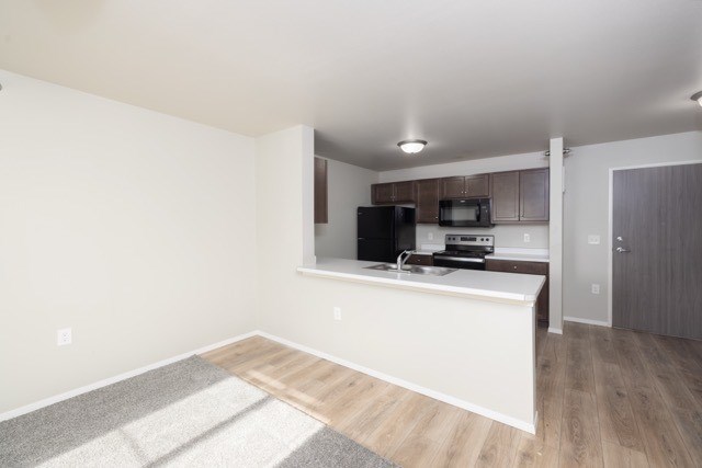 A kitchen area with a countertop and cabinets.