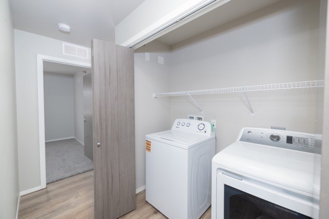 A small kitchen with a white oven and a white cabinet.