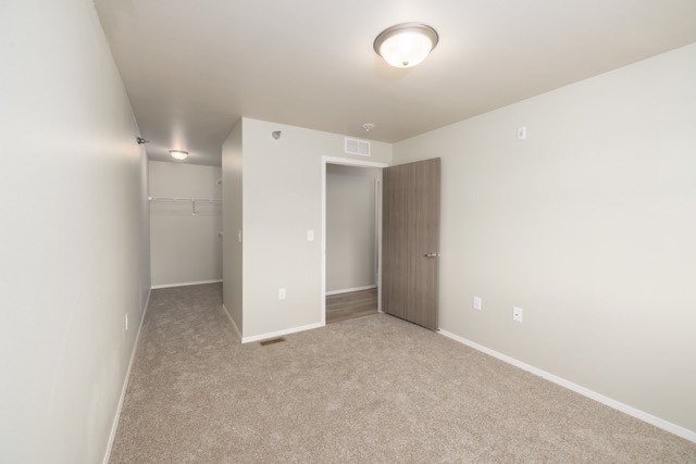 A room with a carpeted floor and a ceiling light.