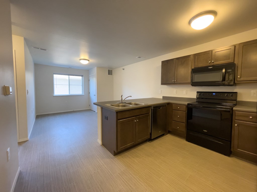 an empty kitchen and living room in an empty apartment