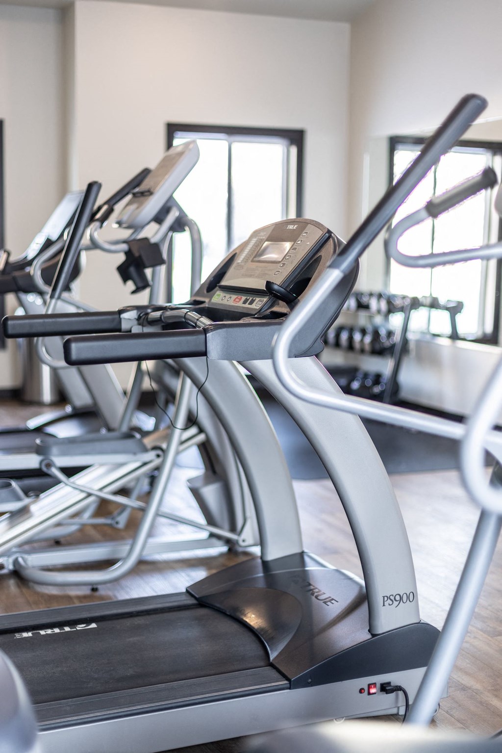 a group of exercise bikes in a gym