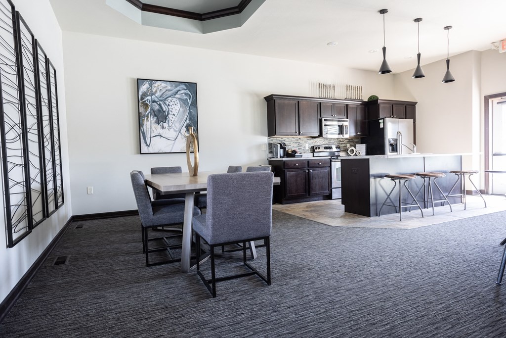 a kitchen and dining room with a table and chairs