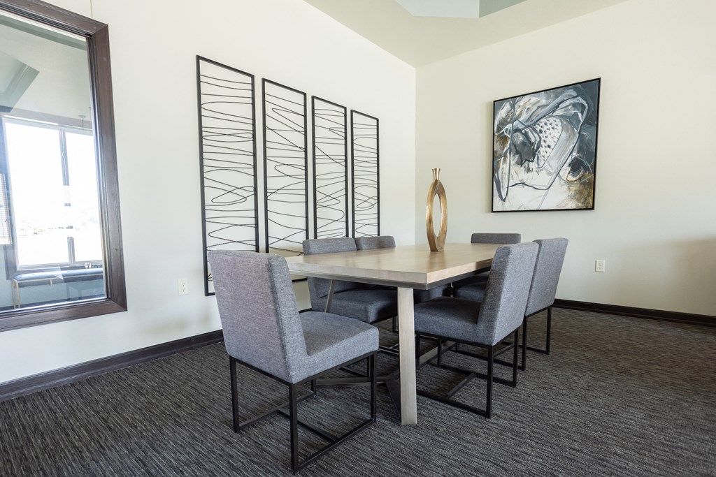 an image of a dining room with a table and chairs