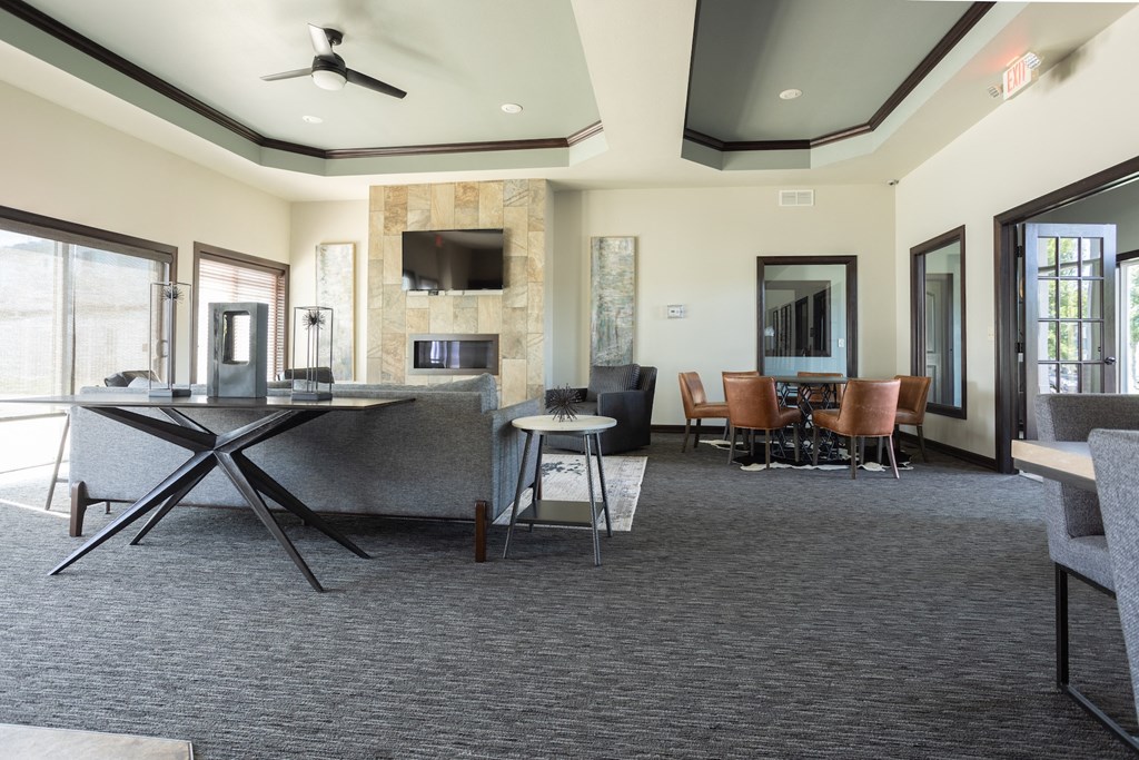 a clubhouse with a dining area and a table with chairs