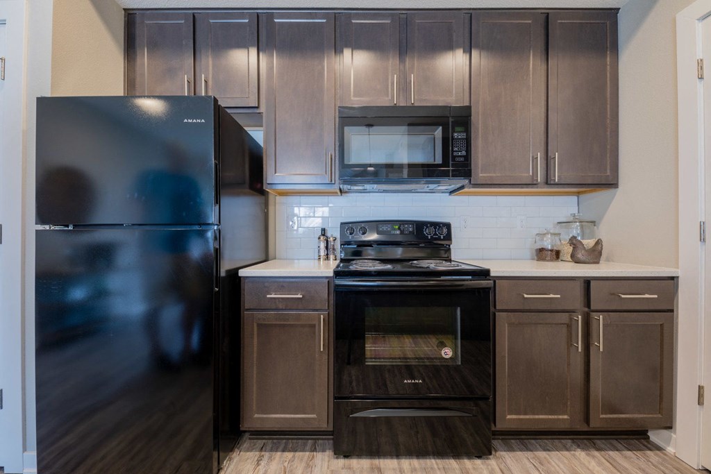 a kitchen with stainless steel appliances and wooden cabinets
