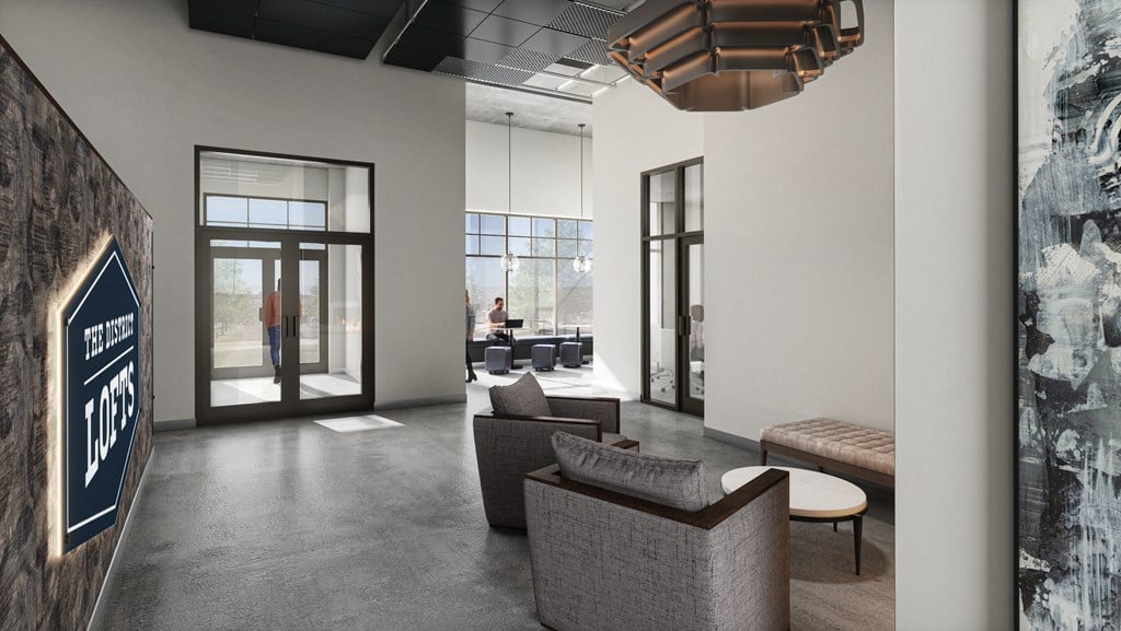 a lobby with couches and chairs and a wall with a lobby sign and doors