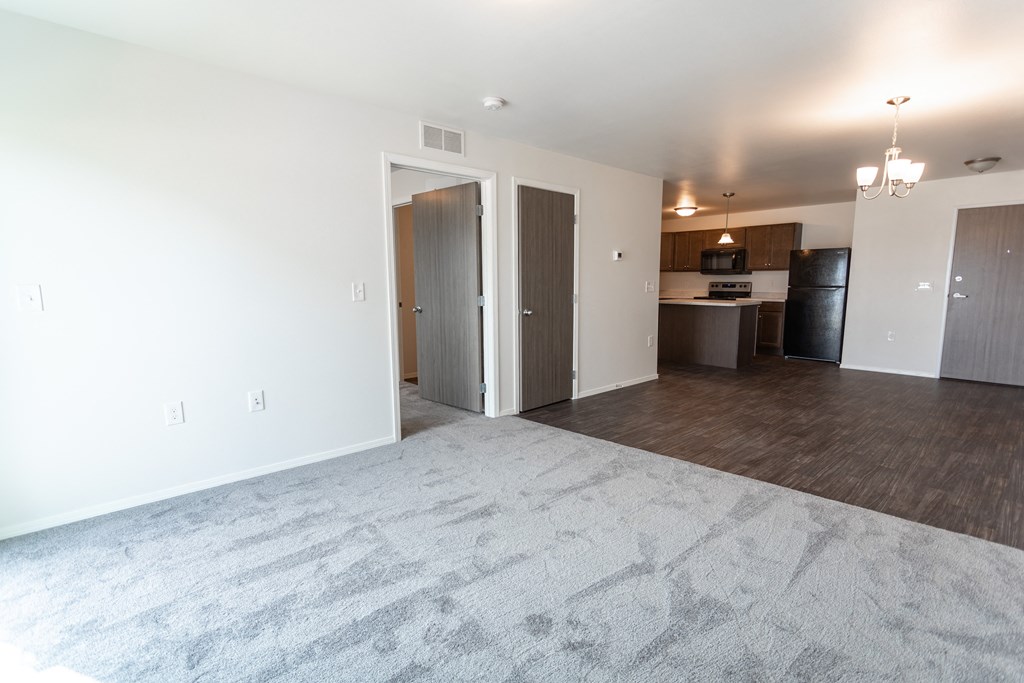 an empty living room and kitchen in a new home