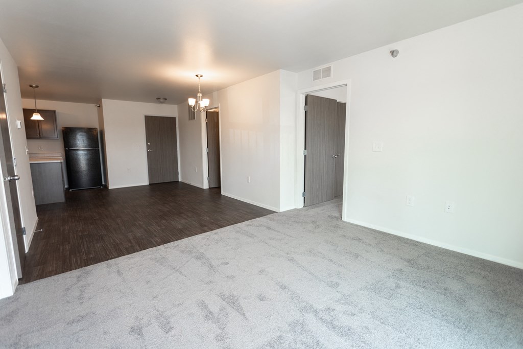 an empty living room and kitchen in a new home