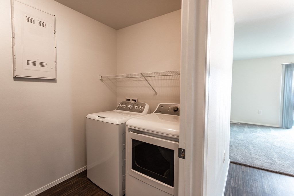 a washer and dryer in a small room in a room with a window