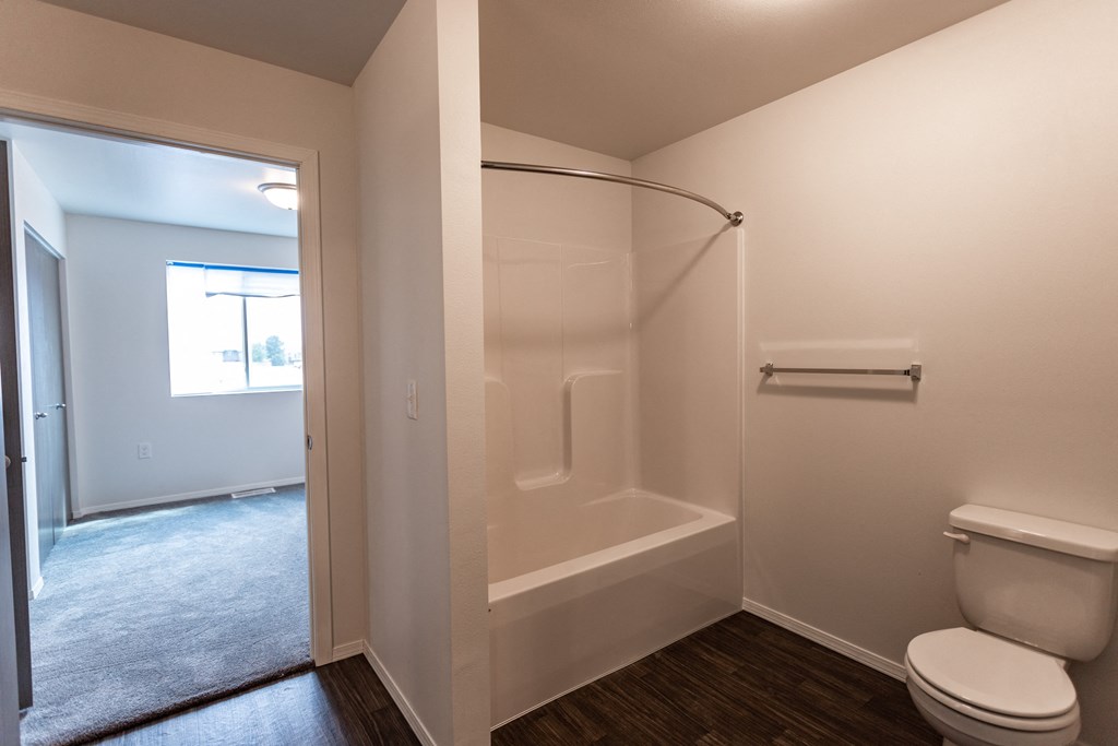 an empty bathroom with a toilet and a shower