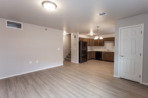an empty living room and kitchen in an empty apartment
