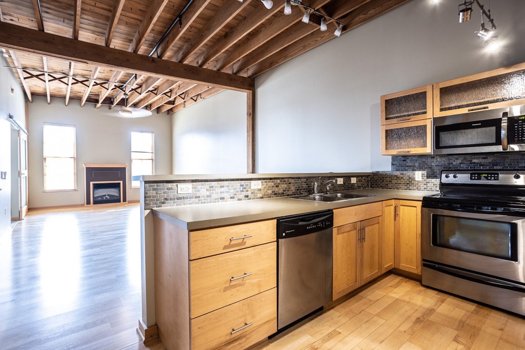 a kitchen with stainless steel appliances and wooden cabinets