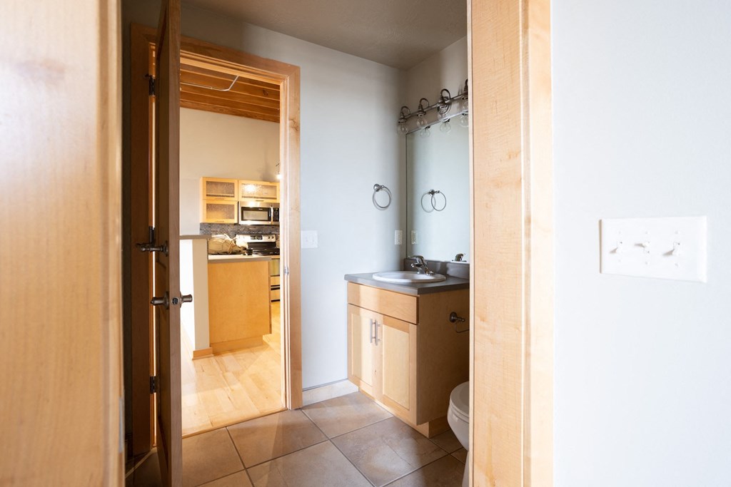 a view into a bathroom with a sink and a toilet