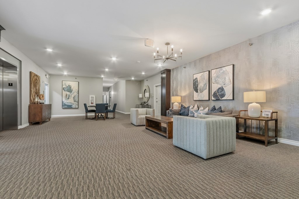 A living room with a grey sofa and a wooden side table.