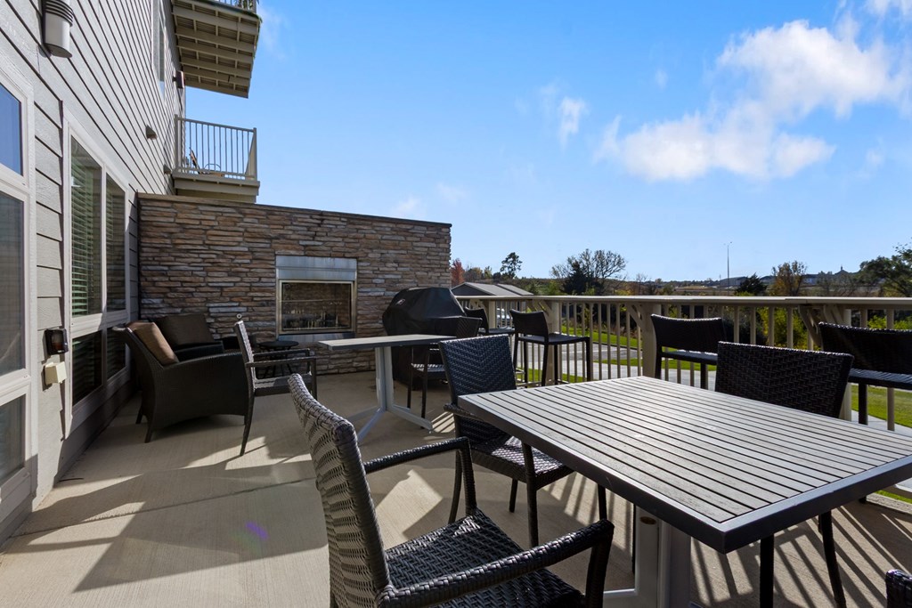 A patio with a table and chairs.