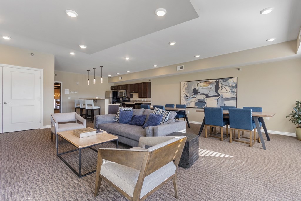 A living room with a grey couch and a wooden chair.