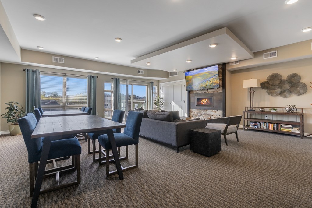 A modern living room with a dining table and chairs.