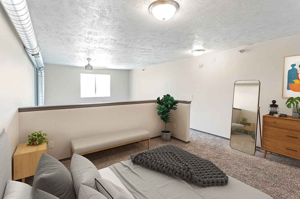 a living room with a bed and a mirror