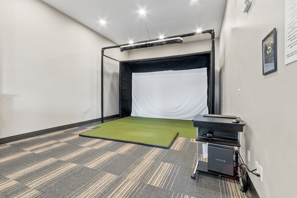 A room with a green mattress and a black table.