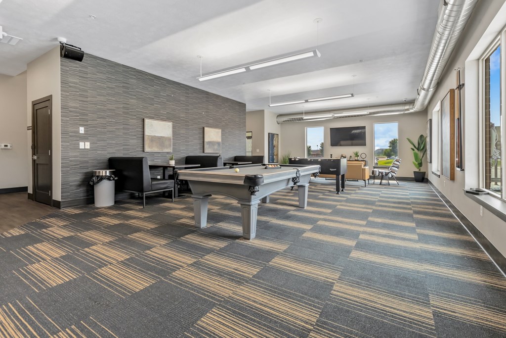 A conference room with a long table and chairs.