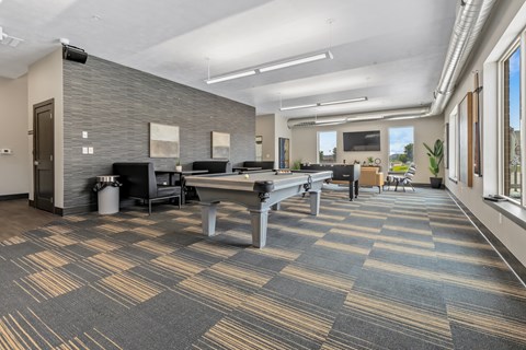 A conference room with a long table and chairs.