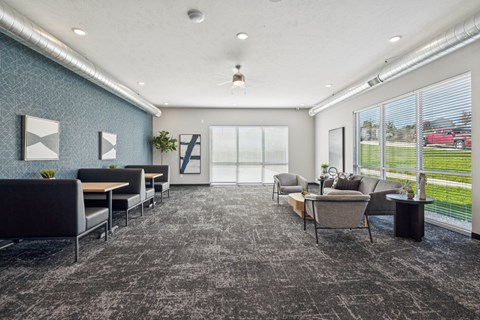 A spacious waiting room with grey carpeting and a variety of seating options.