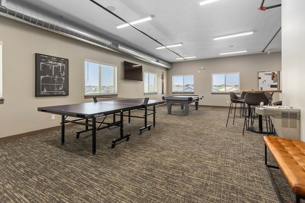 A conference room with a table, chairs, and a bench.