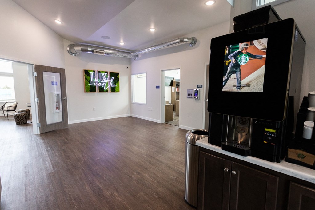 a living room with a tv and a wood floor